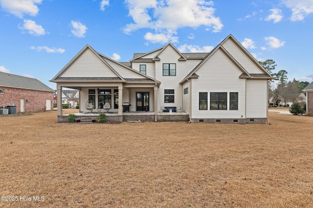 rear view of property featuring a yard and a patio area