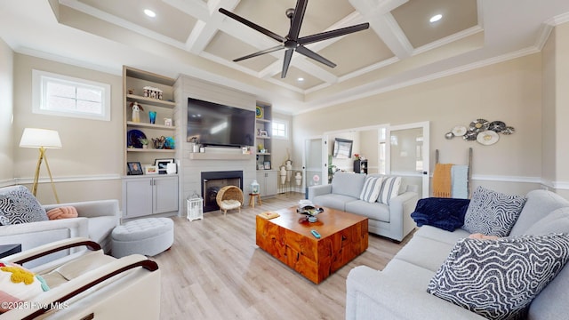 living room with crown molding, plenty of natural light, coffered ceiling, and light wood-type flooring