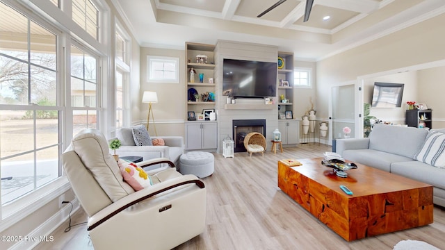 living room featuring coffered ceiling, beam ceiling, ornamental molding, a fireplace, and light hardwood / wood-style floors