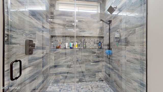 bathroom with a shower with door