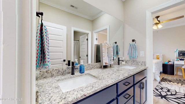 bathroom featuring vanity, crown molding, and ceiling fan