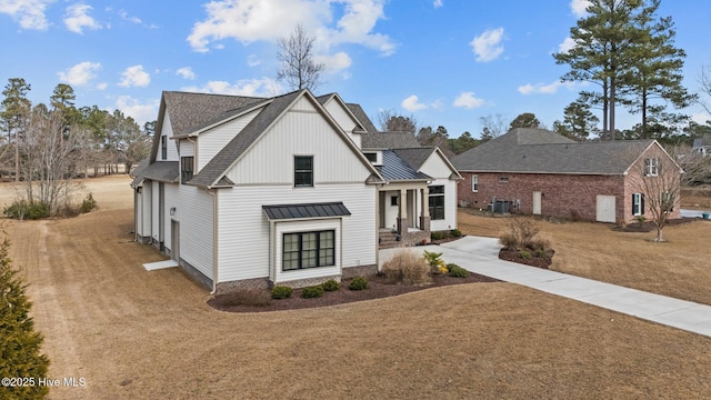 modern inspired farmhouse featuring a front yard and cooling unit