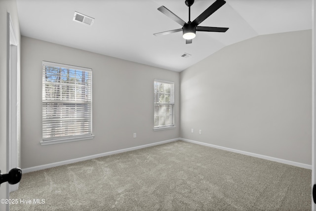 carpeted spare room with ceiling fan and lofted ceiling