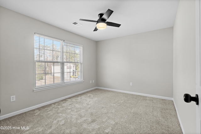 carpeted spare room featuring ceiling fan