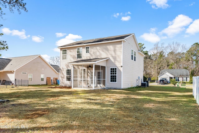 back of house featuring central air condition unit, a lawn, a sunroom, and ceiling fan