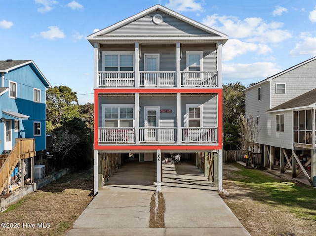 raised beach house with a carport and central AC unit