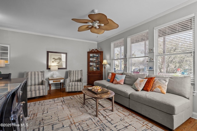 living room featuring ornamental molding, hardwood / wood-style floors, and ceiling fan