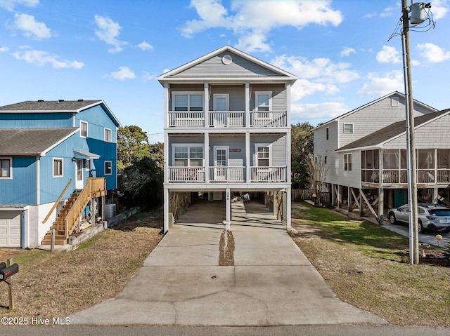 raised beach house with central AC, a carport, and a balcony