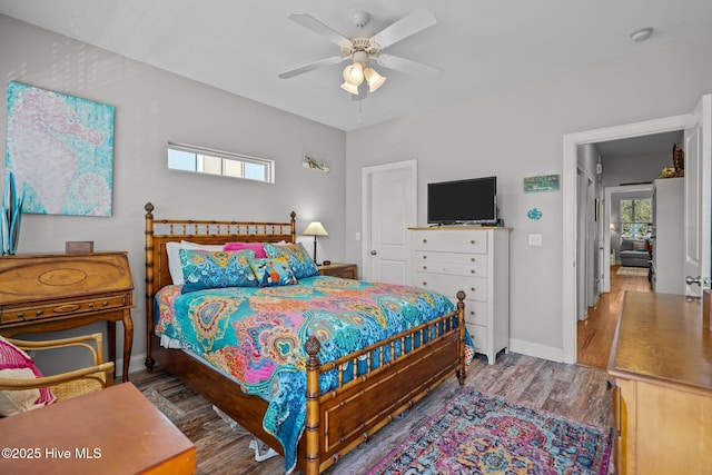 bedroom with dark hardwood / wood-style floors and ceiling fan