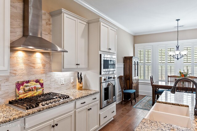 3604 Haughton Ln, Castle Hayne, NC 28429 - kitchen with stainless steel appliances, wall chimney exhaust hood, a sink, a chandelier, and ornamental molding