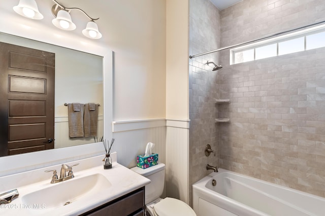 3604 Haughton Ln, Castle Hayne, NC 28429 - full bath featuring toilet, vanity, a wainscoted wall, and washtub / shower combination