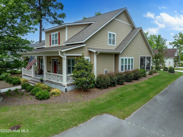 3604 Haughton Ln, Castle Hayne, NC 28429 - view of front of home with covered porch, roof with shingles, and a front lawn