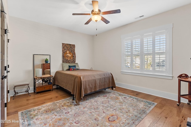 3604 Haughton Ln, Castle Hayne, NC 28429 - bedroom with wood finished floors, baseboards, and ceiling fan