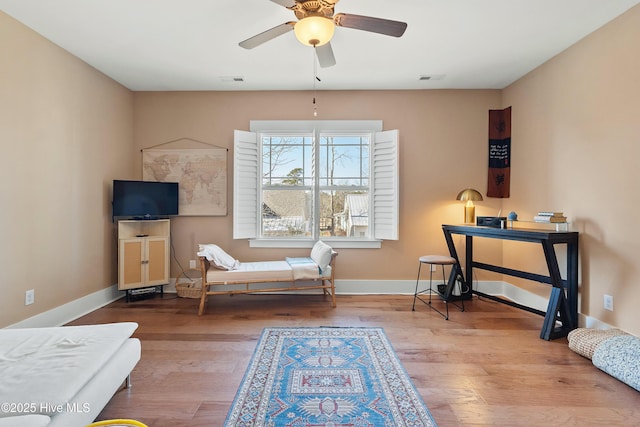 3604 Haughton Ln, Castle Hayne, NC 28429 - living area featuring wood finished floors, a ceiling fan, and baseboards