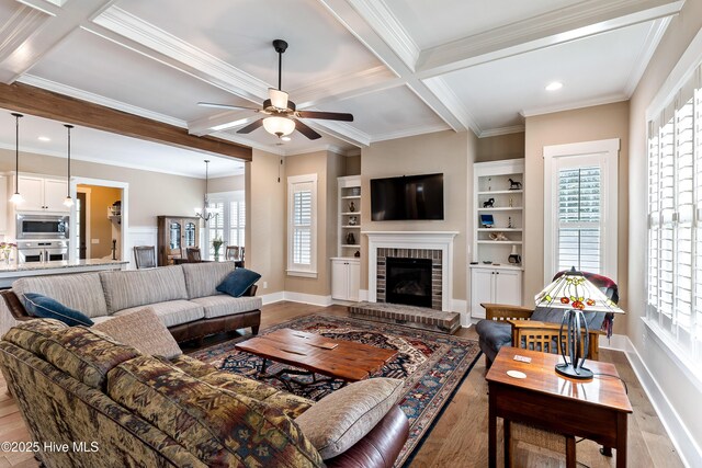 3604 Haughton Ln, Castle Hayne, NC 28429 - living area featuring ceiling fan, wood finished floors, coffered ceiling, beam ceiling, and crown molding
