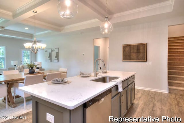 kitchen with sink, an island with sink, decorative light fixtures, stainless steel dishwasher, and beamed ceiling