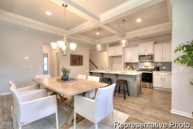 dining room featuring beamed ceiling, a chandelier, coffered ceiling, crown molding, and light hardwood / wood-style flooring