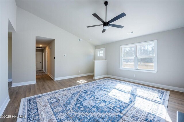 unfurnished room featuring wood-type flooring, high vaulted ceiling, and ceiling fan