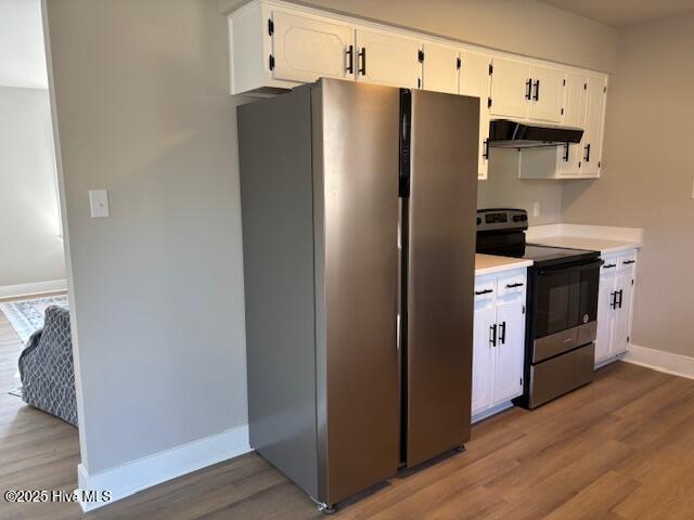 kitchen featuring hardwood / wood-style flooring, white cabinetry, and appliances with stainless steel finishes