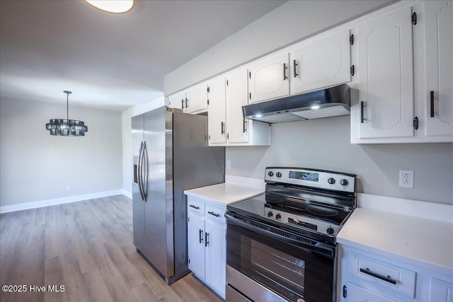 kitchen with light hardwood / wood-style flooring, appliances with stainless steel finishes, an inviting chandelier, hanging light fixtures, and white cabinets