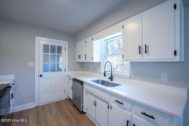 kitchen with black electric range oven, sink, light hardwood / wood-style flooring, white cabinets, and stainless steel dishwasher