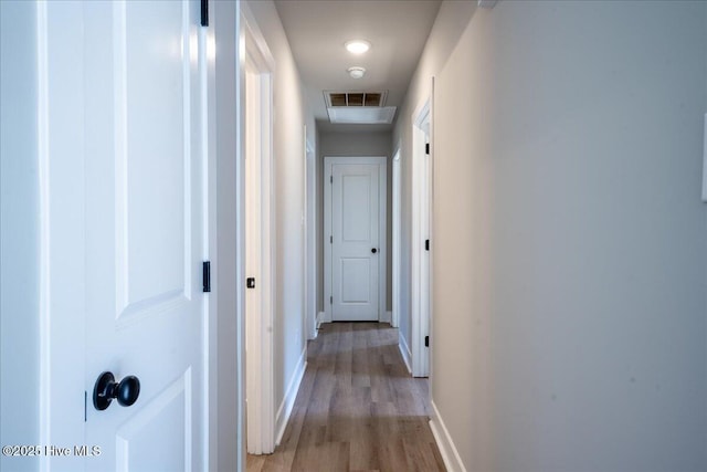 corridor with light hardwood / wood-style floors