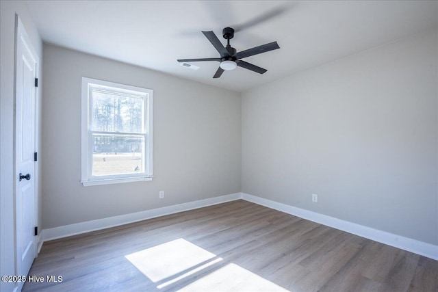 spare room with ceiling fan and light wood-type flooring