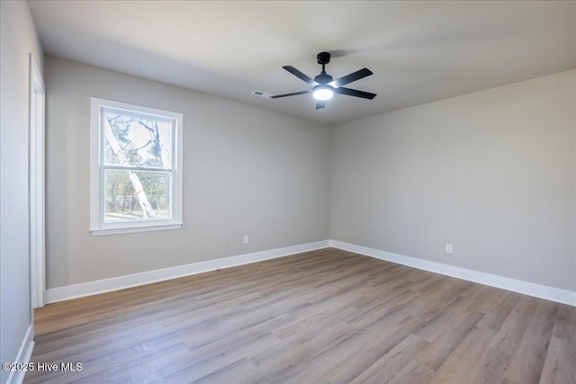 unfurnished room with ceiling fan and light wood-type flooring