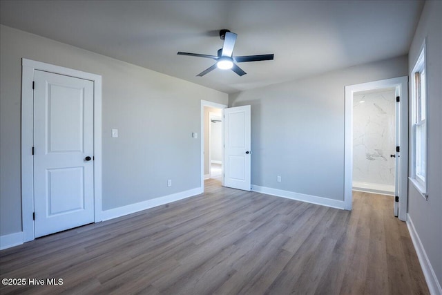 unfurnished bedroom with ceiling fan, ensuite bath, and light hardwood / wood-style flooring