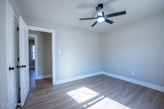 unfurnished room with hardwood / wood-style floors and ceiling fan