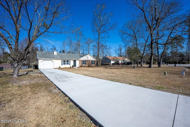 ranch-style house with a garage and a front lawn