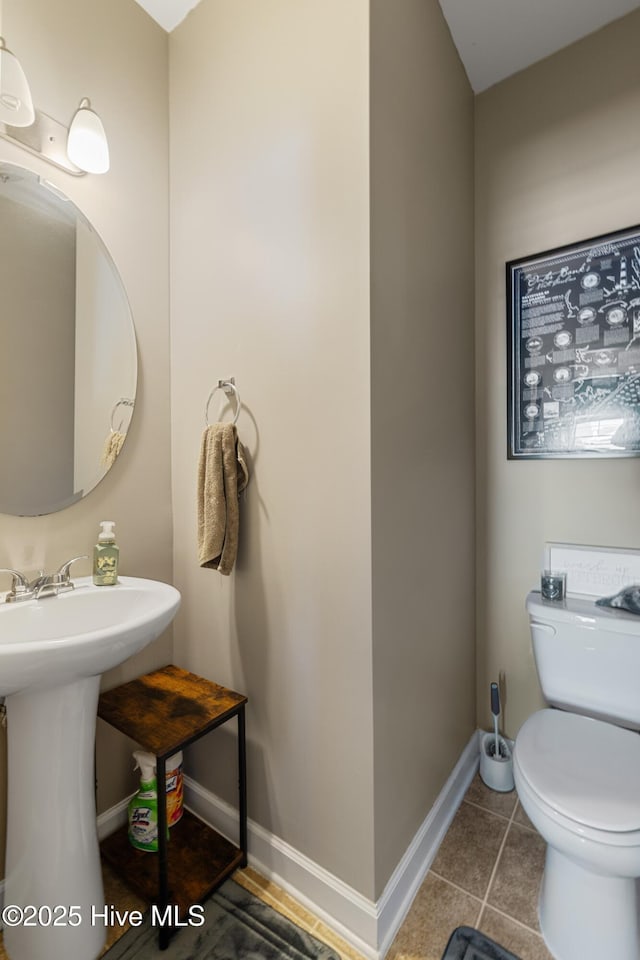 bathroom with sink, tile patterned floors, and toilet