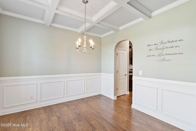 unfurnished dining area featuring a chandelier, beamed ceiling, arched walkways, and coffered ceiling