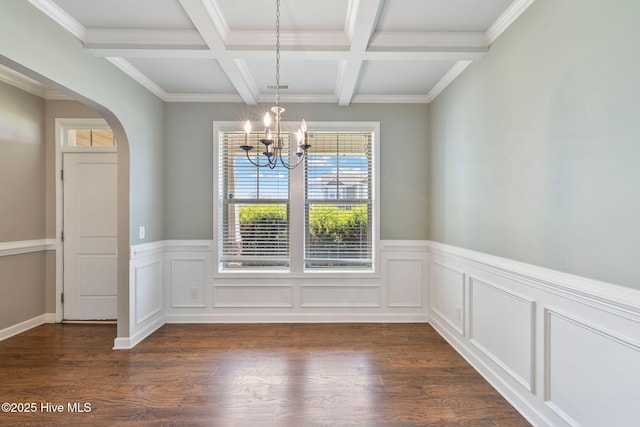 unfurnished dining area featuring arched walkways, an inviting chandelier, beamed ceiling, and dark wood-style flooring