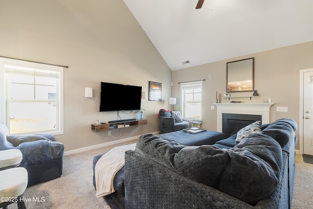 living room featuring light carpet, high vaulted ceiling, and ceiling fan