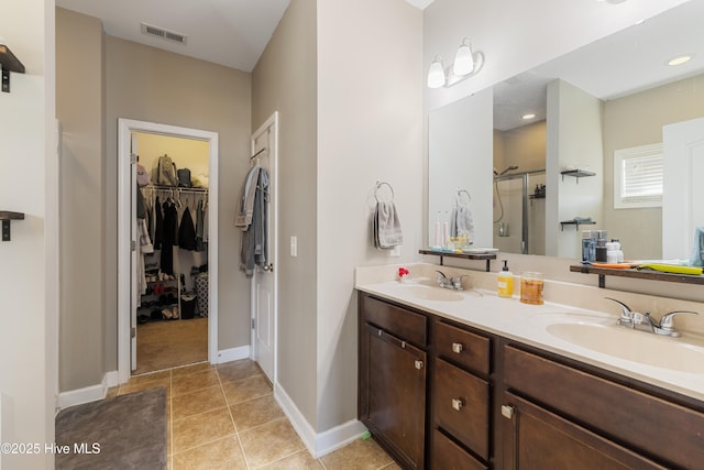 bathroom with vanity, tile patterned floors, and a shower with shower door