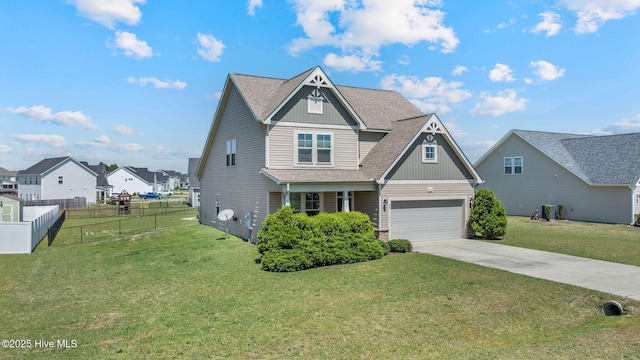 view of front of home with a shingled roof, a garage, fence, a front lawn, and driveway