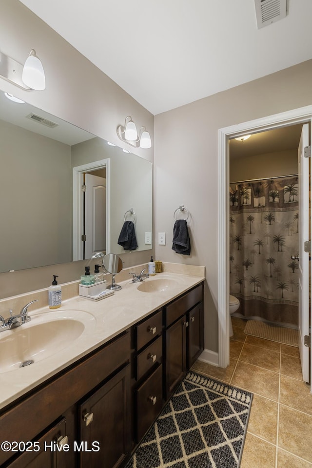 bathroom featuring tile patterned floors, toilet, and vanity