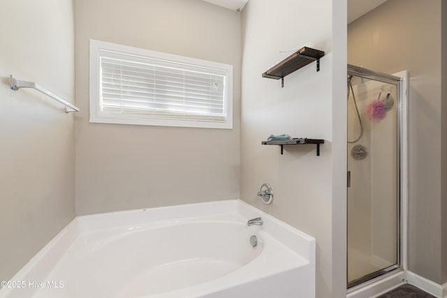 bathroom with shower with separate bathtub