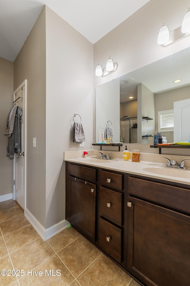 bathroom featuring an enclosed shower, vanity, and tile patterned floors