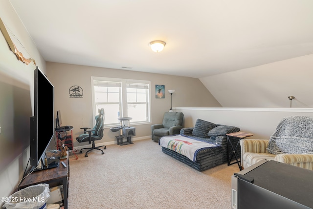 carpeted home office featuring vaulted ceiling