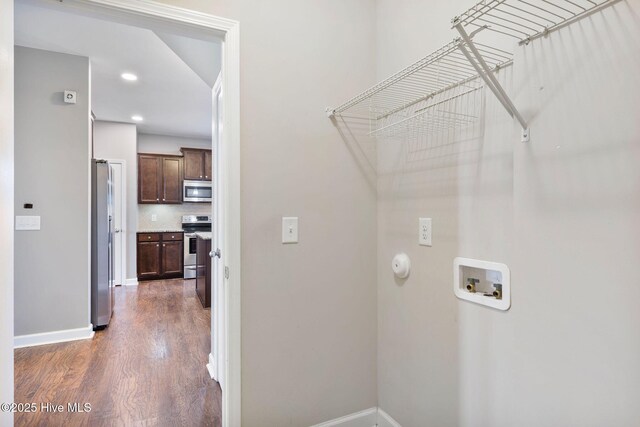 washroom with recessed lighting, baseboards, hookup for a washing machine, and wood finished floors