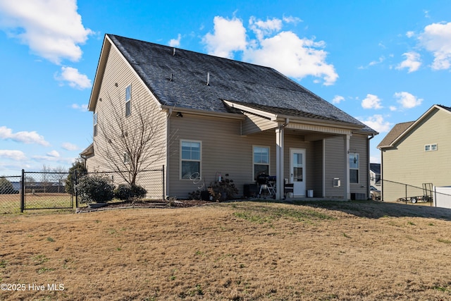 rear view of house featuring a lawn