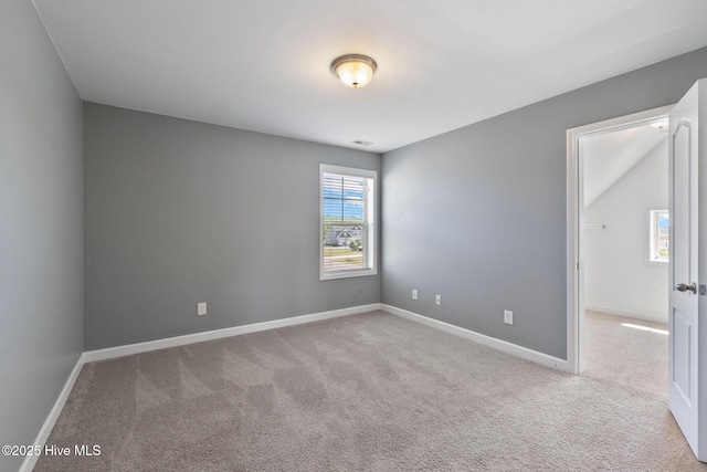 unfurnished room featuring carpet flooring, baseboards, and visible vents