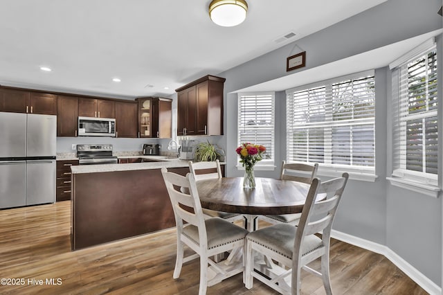 dining space featuring hardwood / wood-style flooring and sink