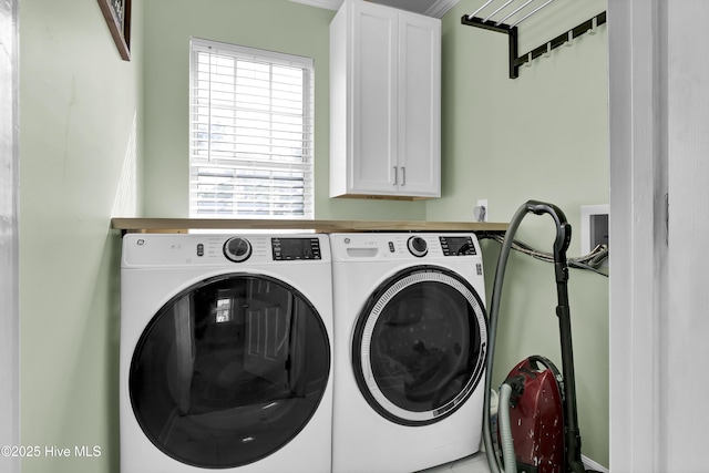 washroom with cabinets and washing machine and dryer