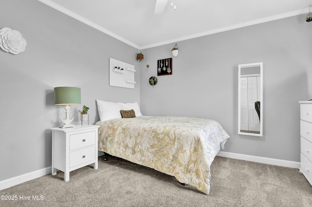 carpeted bedroom featuring crown molding and ceiling fan