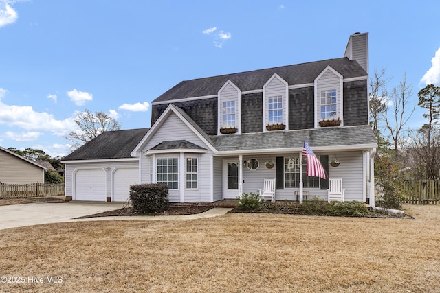 view of front of house with a garage, a porch, and a front lawn