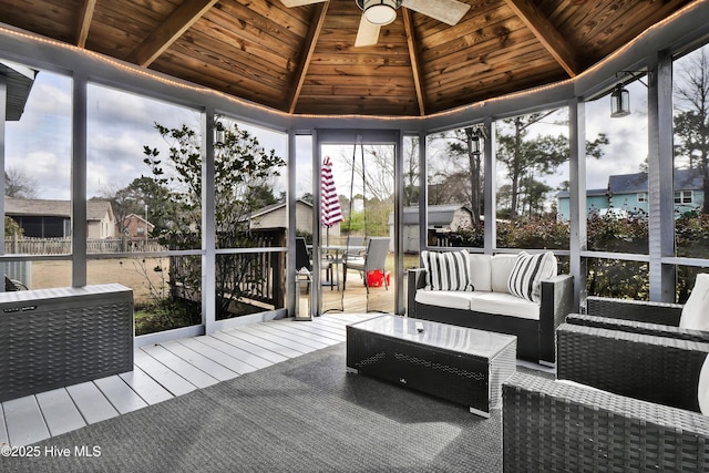 sunroom / solarium featuring lofted ceiling, wood ceiling, and ceiling fan