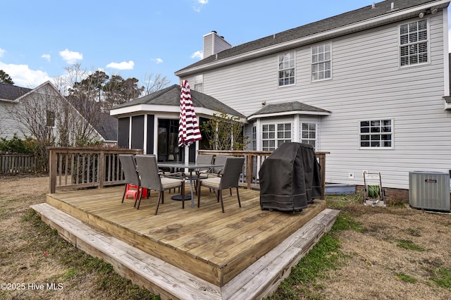 wooden terrace with a sunroom, a grill, and cooling unit